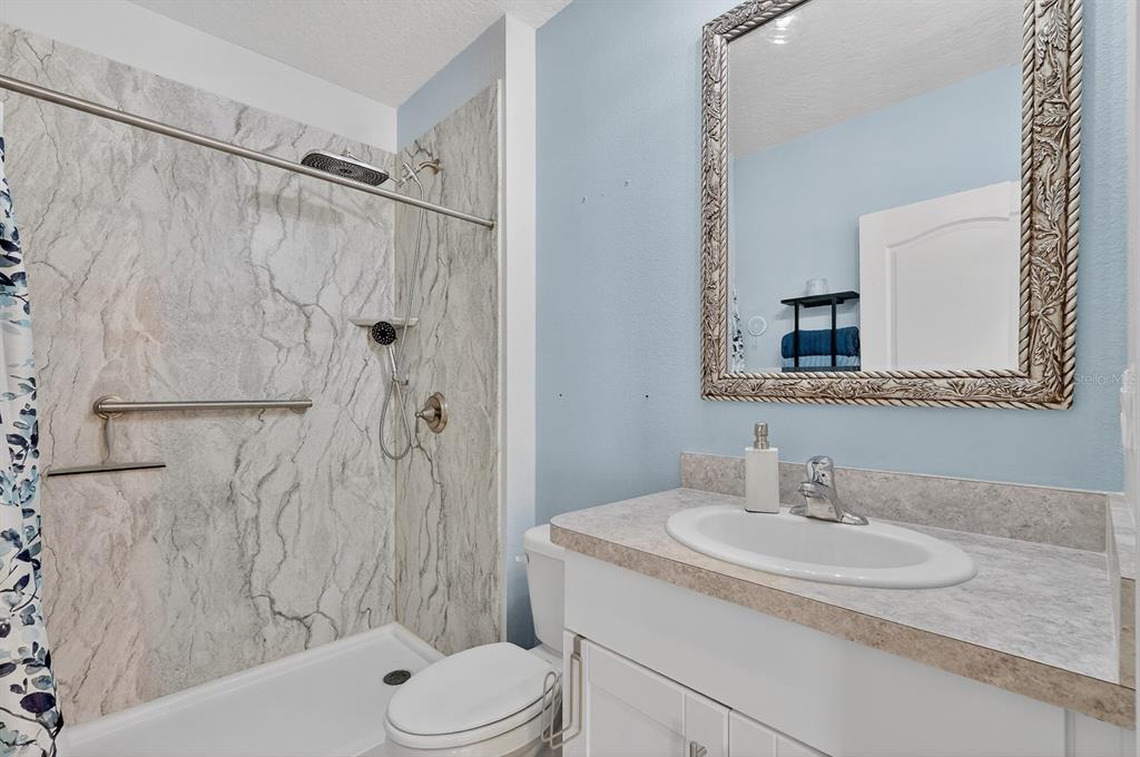 1809 Myrtlebrooke Drive Edgewater, FL 32141 - Photo 33 of 58 a bathroom with a sink toilet and shower
