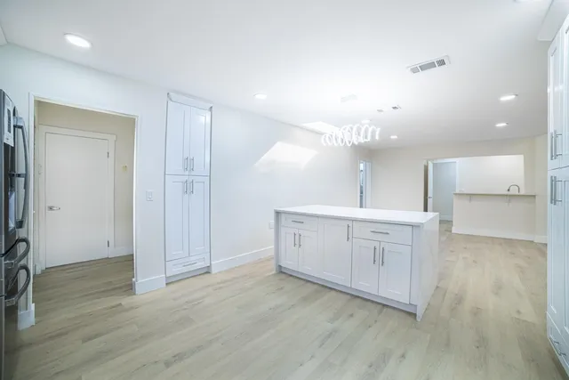 a kitchen with a sink cabinets and window
