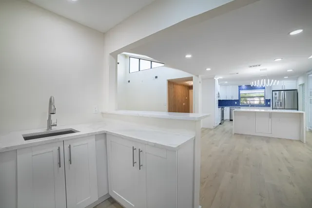 an empty room with wooden floor and closet area