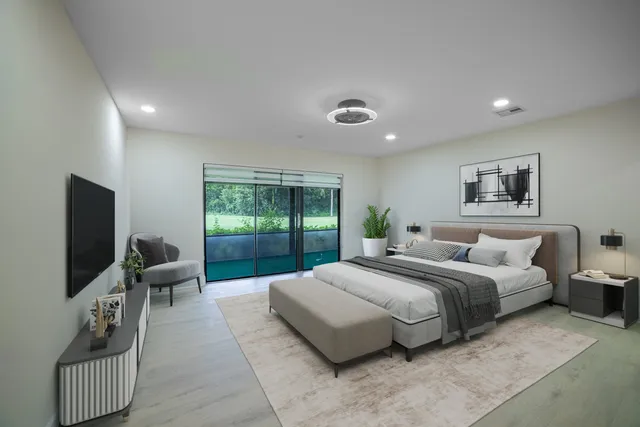 a large bedroom with a bed and large window