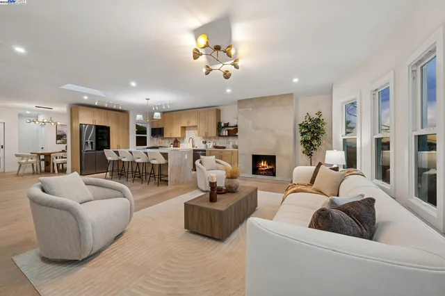 a view of a dining room with furniture and a chandelier