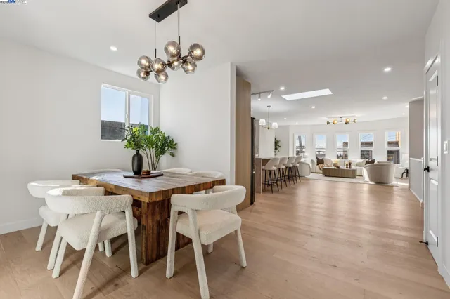 a view of a dining room with furniture and chandelier