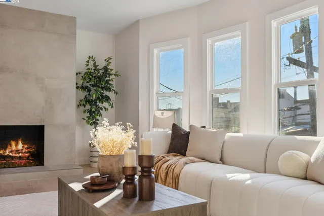 a living room with furniture a dining table and a chandelier