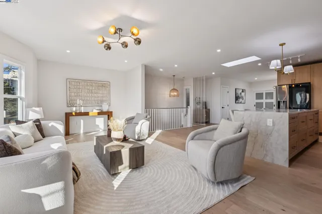 a living room with furniture a window and a potted plant