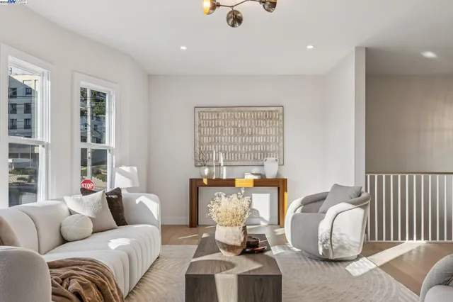 a living room with furniture a mirror and a lamp