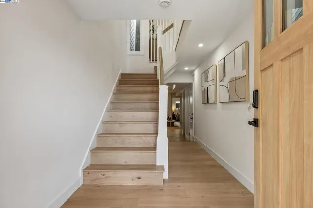 a view of entryway and hall with wooden floor