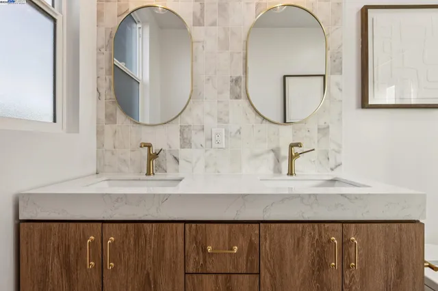 a bathroom with a shower sink vanity mirror and toilet