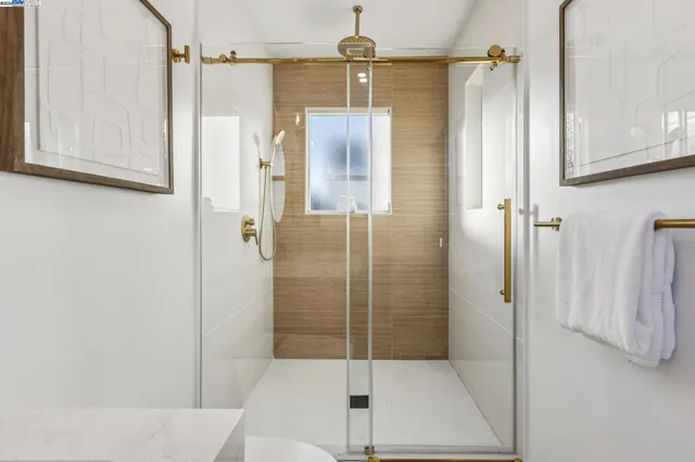 a bedroom with a large bed and a potted plant