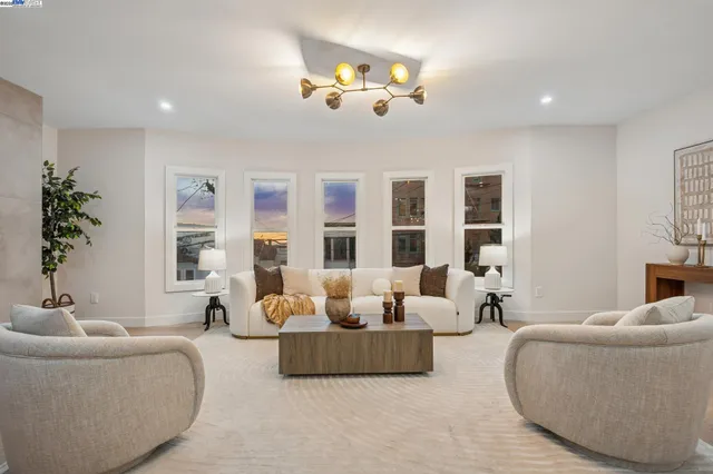 a living room with furniture and a chandelier