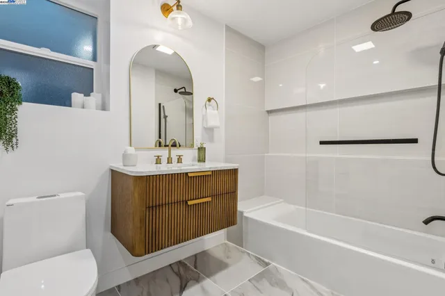 a bedroom with bed and a potted plant