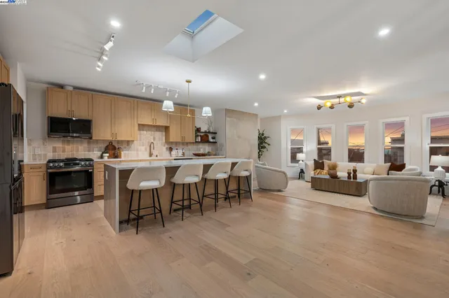 a living room with furniture a fireplace and a chandelier