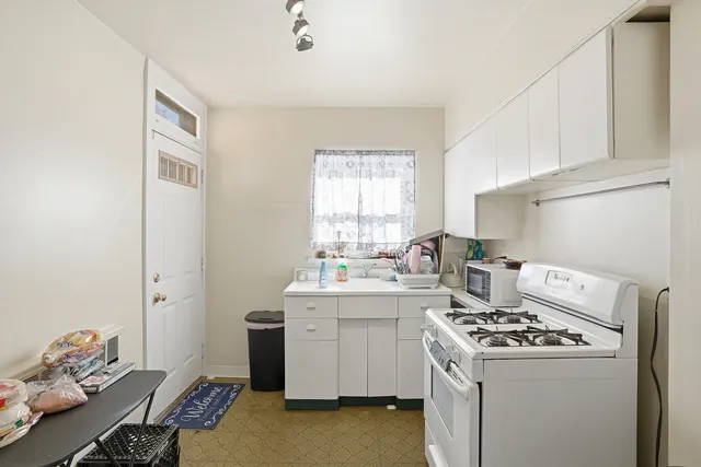 a living room with furniture and a mirror