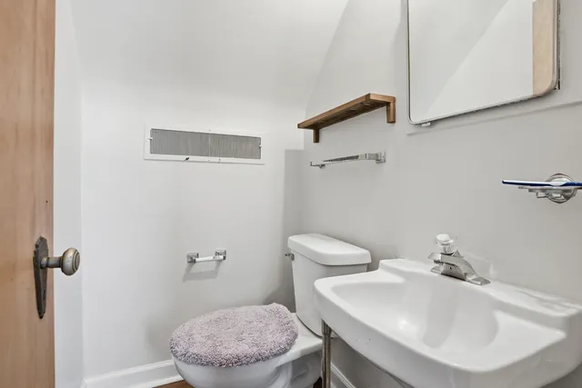 a living room with furniture a chandelier and a fireplace