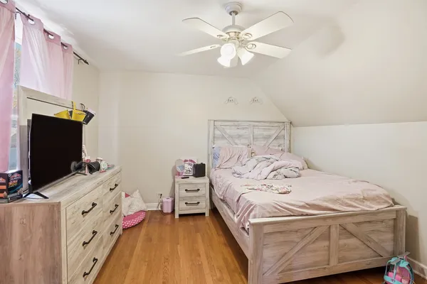 a living room with furniture a piano and a chandelier