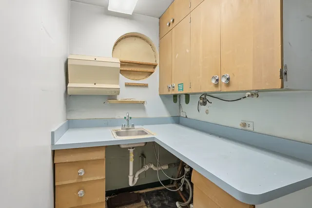 a bathroom with a sink mirror and toilet