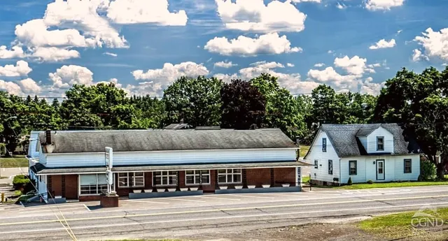 a view of street along with residential houses