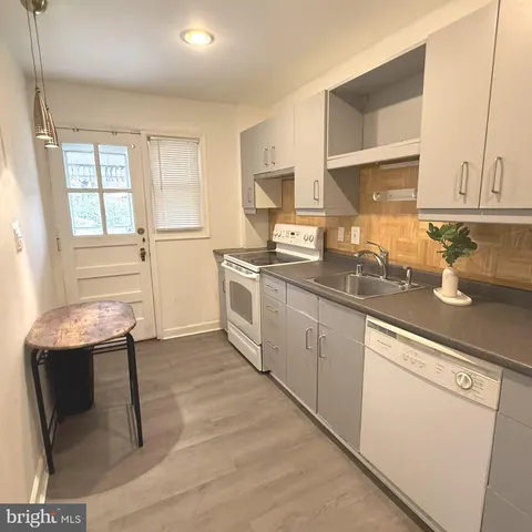 a kitchen with a sink cabinets and window