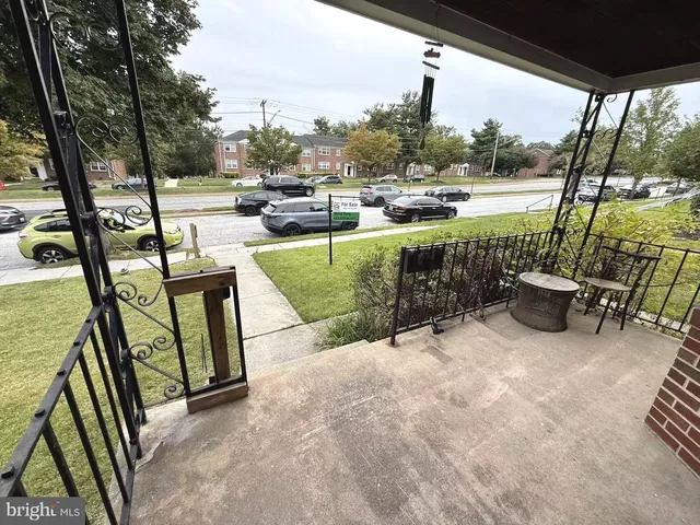 a view of a swimming pool with a patio and a yard
