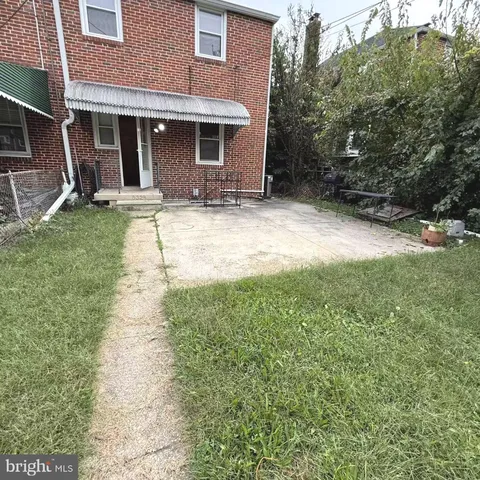 a backyard of a house with yard and outdoor seating