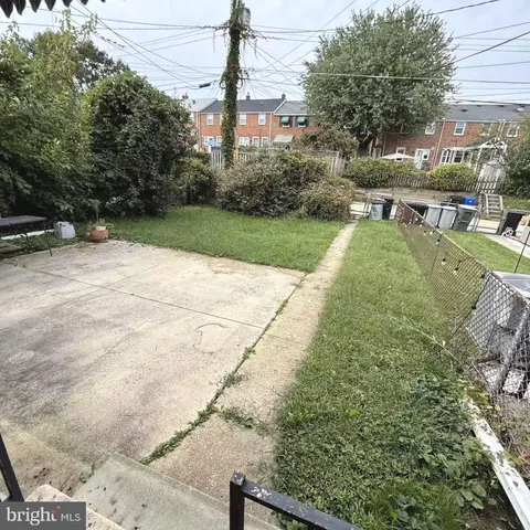 a view of yard with seating area and trees