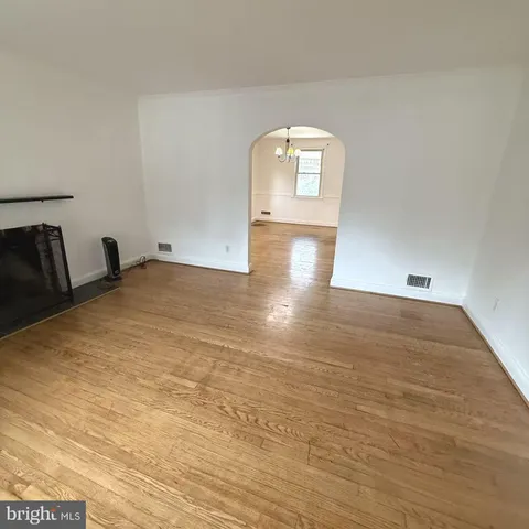 a view of a room with wooden floor and glass door