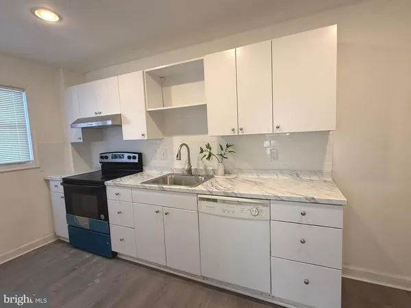 a kitchen with a sink and cabinets