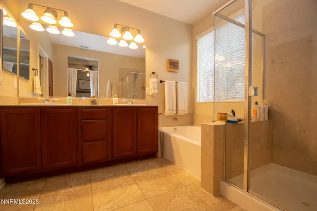 a bathroom with a tub a sink and mirror