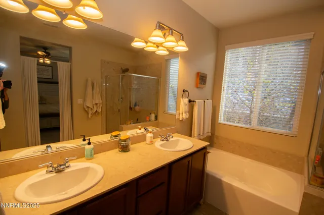 a bathroom with a tub sink and mirror