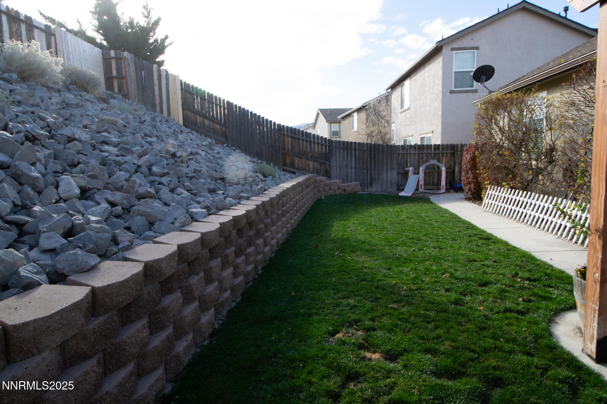 1056 Crown View Drive Reno, NV 89523 - Photo 22 of 27 a view of a backyard with wooden fence