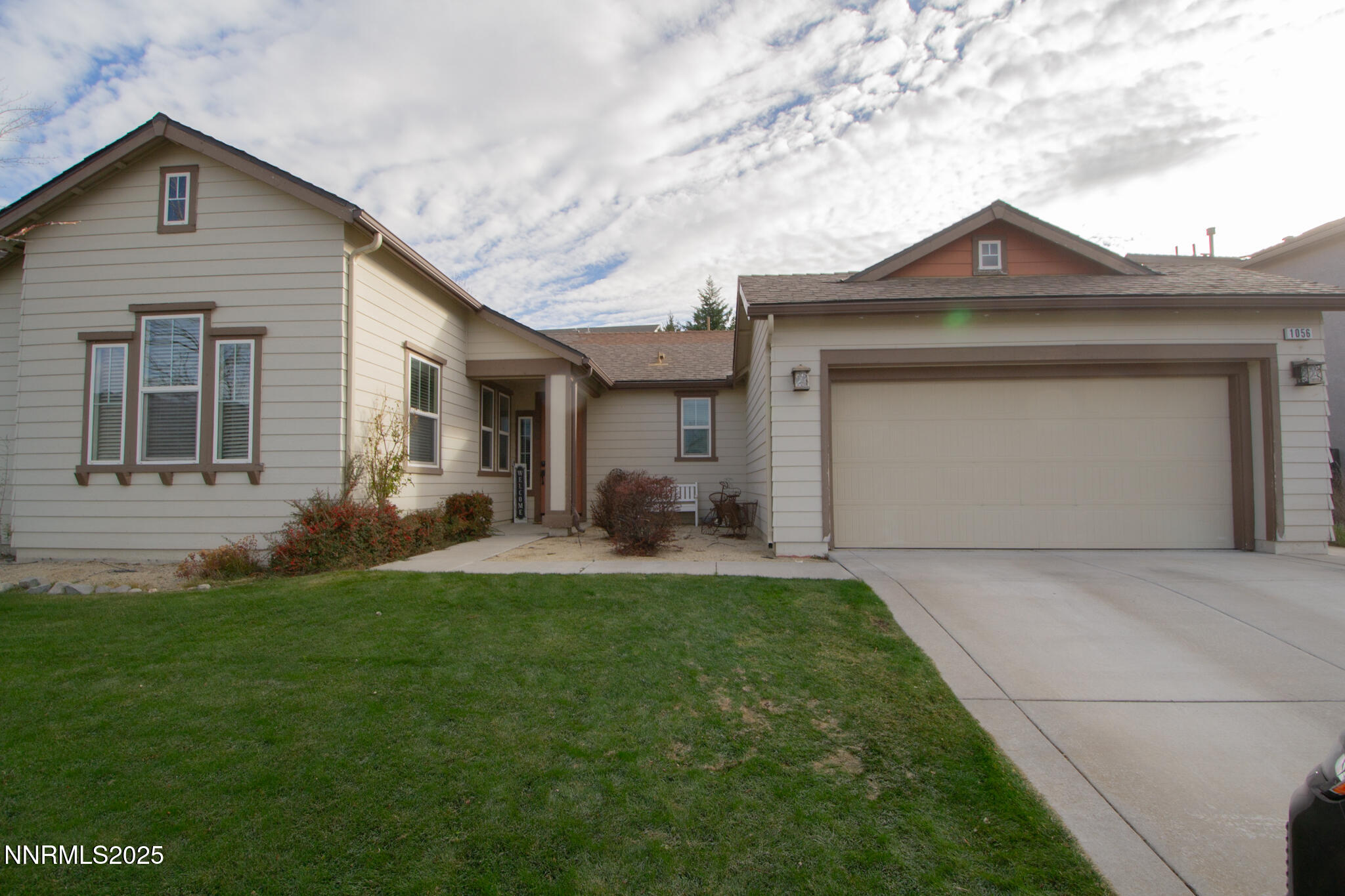 1056 Crown View Drive Reno, NV 89523 - Photo 3 of 27 a front view of a house with a yard and garage
