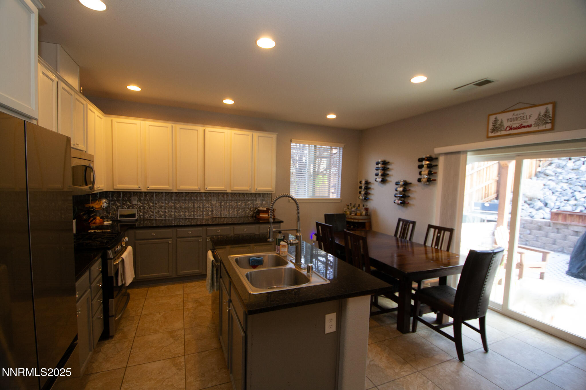1056 Crown View Drive Reno, NV 89523 - Photo 8 of 27 a kitchen with a dining table chairs and refrigerator
