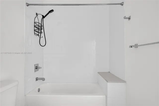 a bathroom with a bath tub with a shower