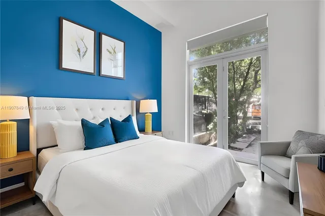 a bedroom with bed and large window