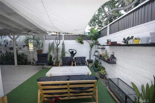 a view of a patio with table and chairs with potted plants