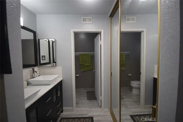 a bathroom with a double vanity sink and a mirror