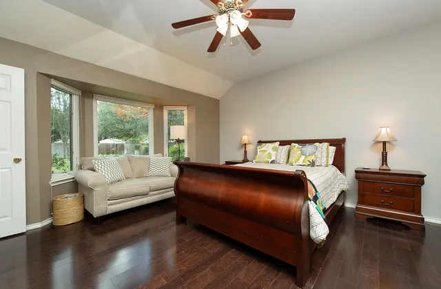 a bedroom with a large bed and a couch