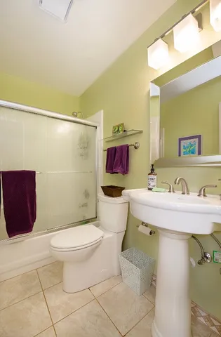 a bathroom with a sink mirror vanity and toilet