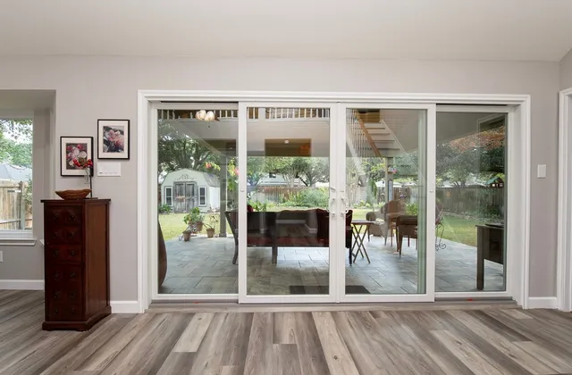 a living room with hardwood floor and floor to ceiling windows