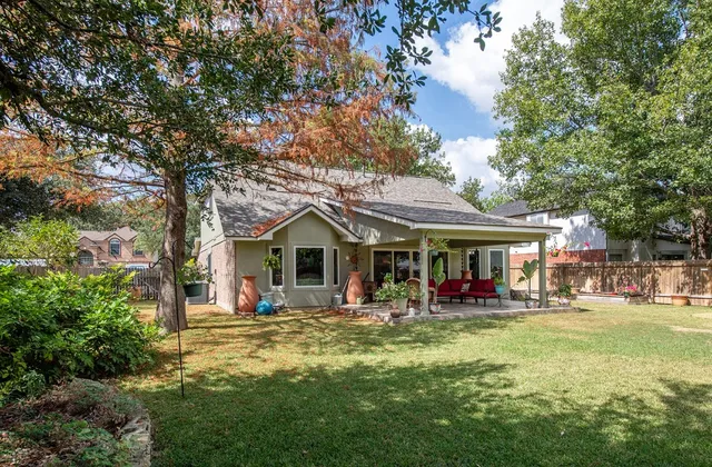 a front view of a house with sitting area and garden
