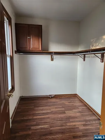 a view of a room with wooden floor and staircase