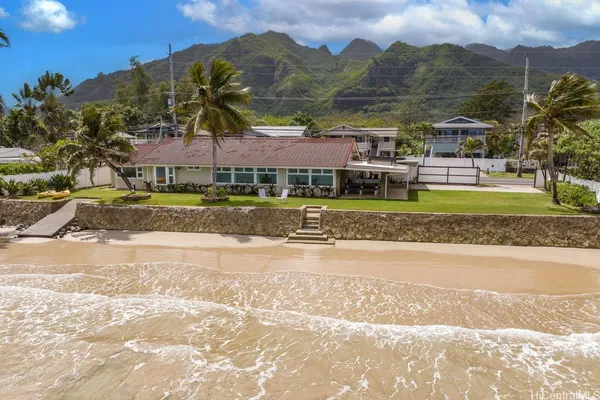 a view of house with a yard and a large tree