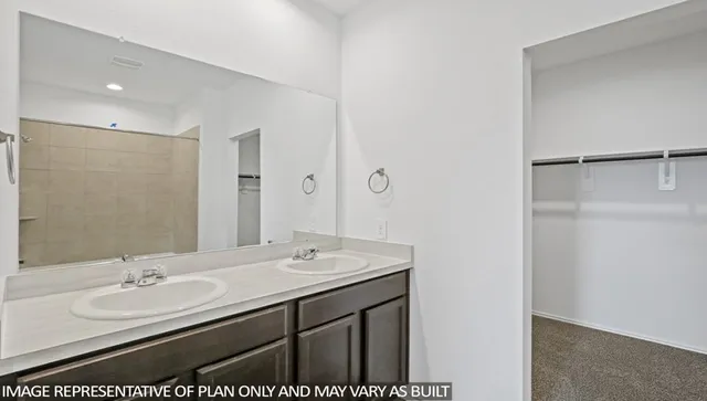 a bathroom with a sink double vanity and a mirror