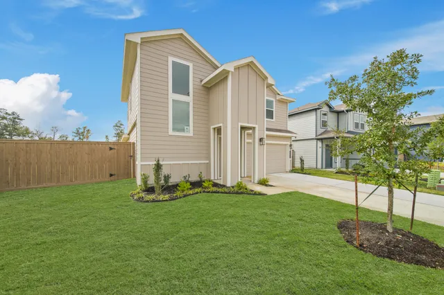 a backyard of a house with plants and a garden