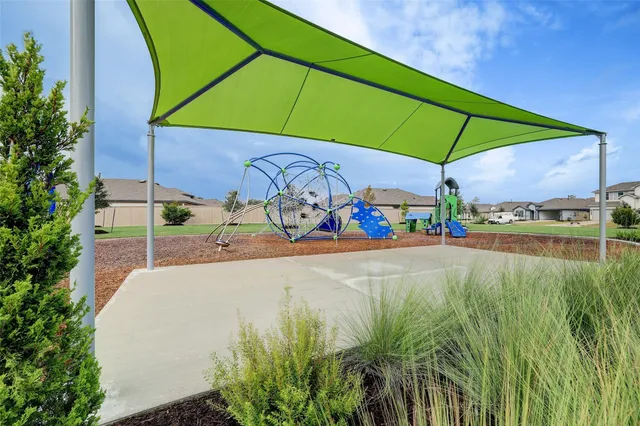 a childrens park with lots of swings and slides