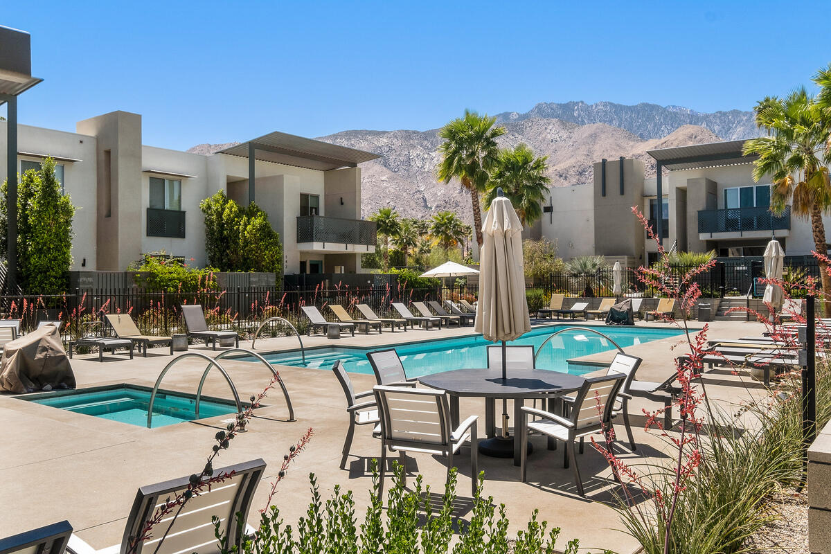 211 The River Palm Springs, CA 92262 - Photo 14 of 21 a view of a patio with table and chairs potted plants and palm tree
