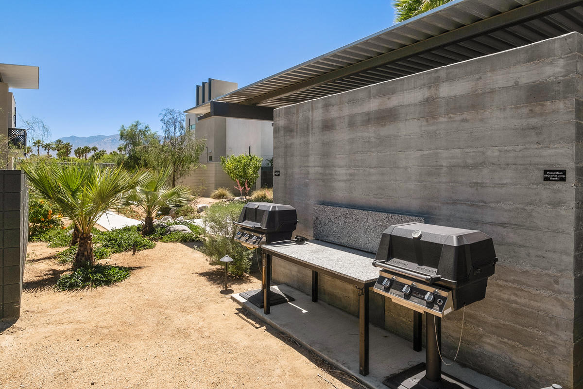 211 The River Palm Springs, CA 92262 - Photo 16 of 21 a backyard of a house with table and chairs
