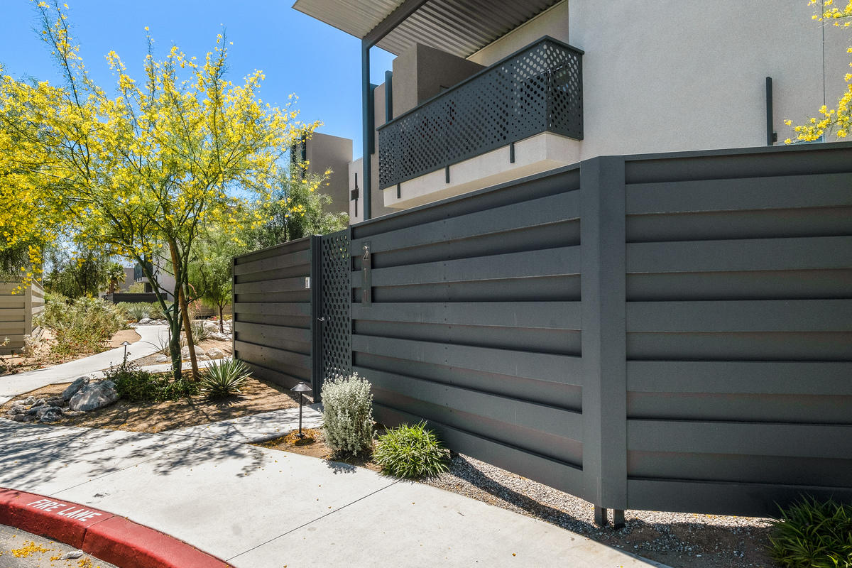211 The River Palm Springs, CA 92262 - Photo 19 of 21 a view of house with wooden fence