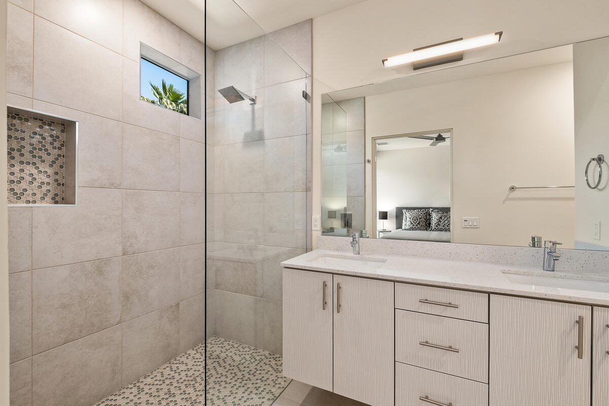 211 The River Palm Springs, CA 92262 - Photo 7 of 21 a bathroom with a shower sink and mirror