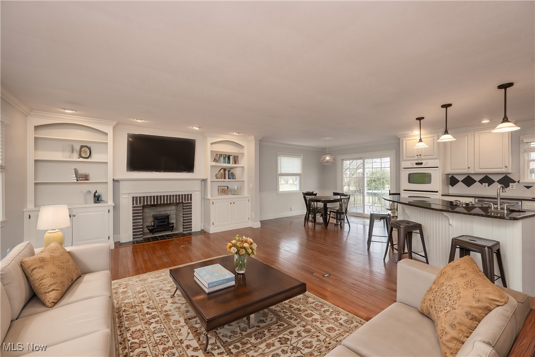 3721 20th Street Northwest Canton, OH 44708 - Photo 2 of 47 Virtually Staged. Living room with crown molding, sink, hardwood / wood-style floors, and a brick fireplace