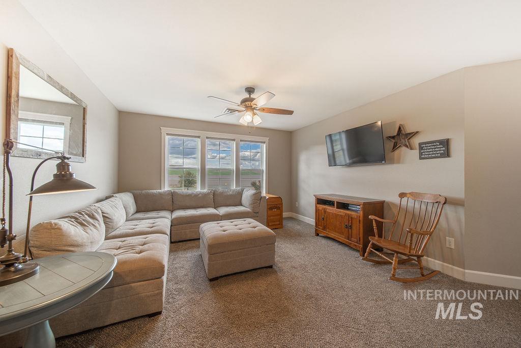 19809 Tammany Creek Road Lewiston, ID 83501 - Photo 24 of 50 Living room featuring plenty of natural light, light colored carpet, and ceiling fan